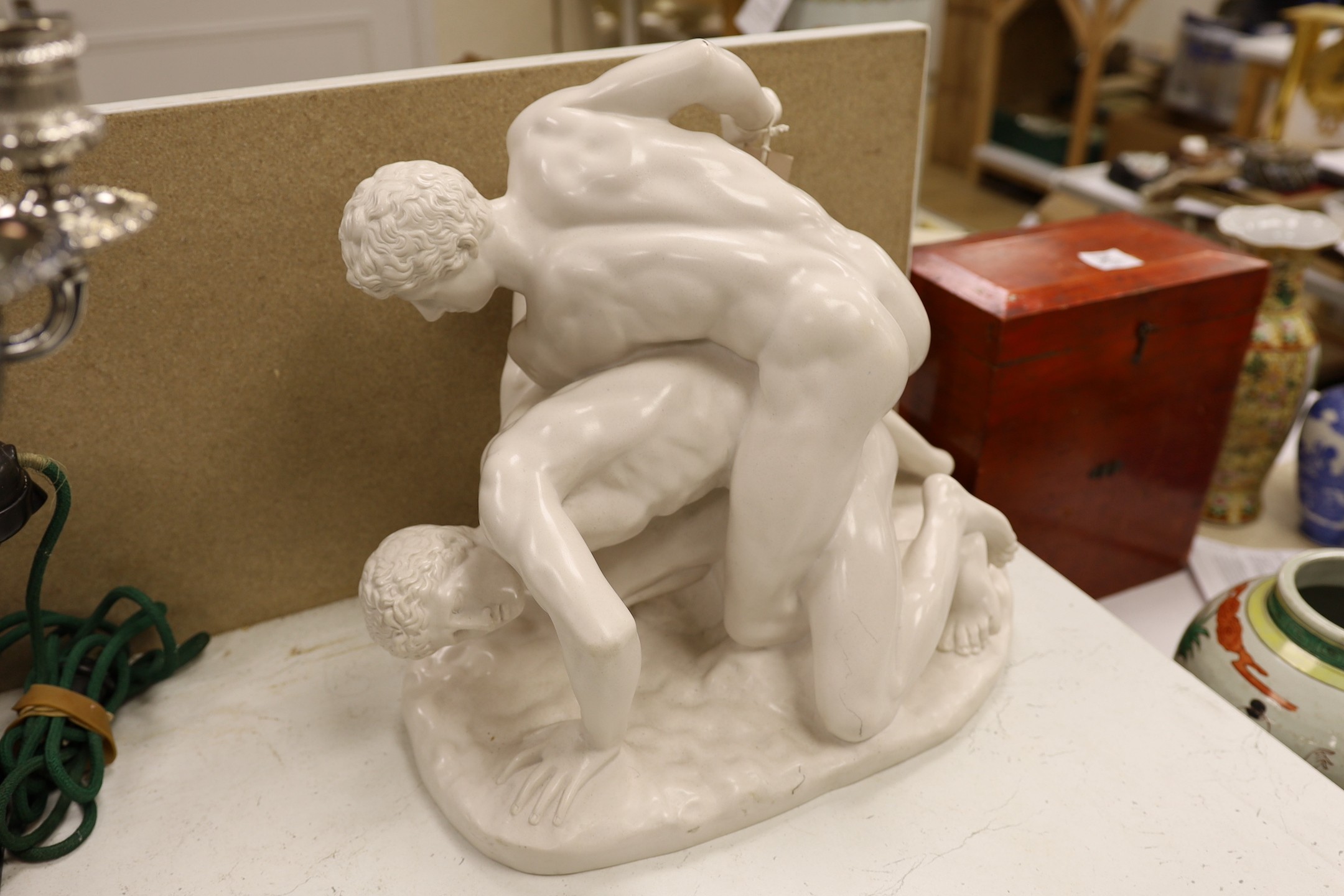 A composite figure group modelled as two wrestling men, ‘sculptured arts studio’, ‘SAS’ and ‘made in England’ stamped to base. 39 cms high